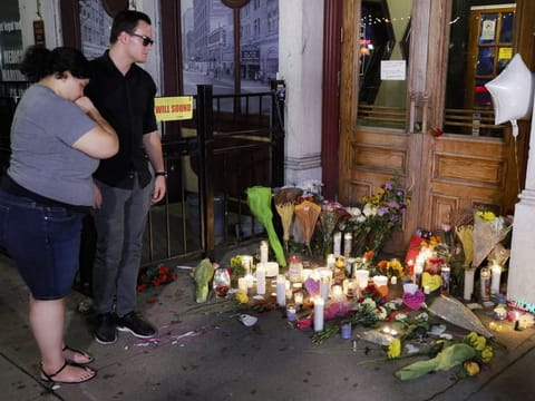 Dayton: Mourners visit a makeshift memorial outside Ned Peppers bar following a vigil at the scene of a mass shooting, Sunday, Aug. 4, 2019, in Dayton, Ohio. 
