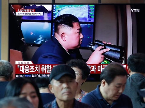 People watch a TV showing a file image of North Korean leader Kim Jong Un during a news program at the Seoul Railway Station in Seoul, South Korea, Tuesday, Aug. 6, 2019.