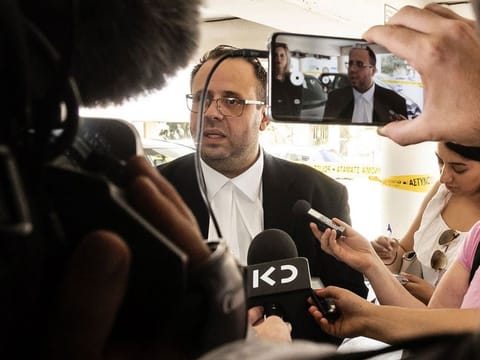 ndreas Pittadjis, the lawyer of a British teenager who was arrested on suspicion of falsely accusing 12 Israeli tourists of gang rape at the hotel where she was staying in the Cypriot popular resort of Ayia Napa on July 17, speaks to the press outside the Famagusta district court. 