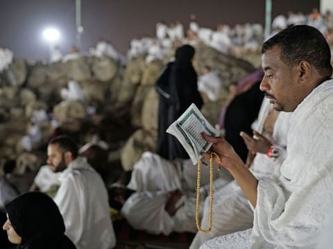 Muslim pilgrims make their way down on a rocky hill known as Mountain of Mercy, on the Plain of Arafat, during the annual Hajj pilgrimage, near the holy city of Makkah, Saudi Arabia, Saturday, August 10, 2019. 