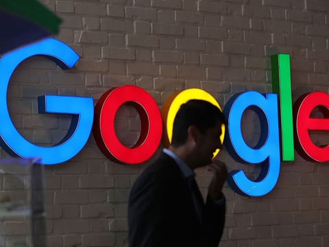 An illuminated Google logo at the company's exhibition stand during the Noah Technology Conference in Berlin.