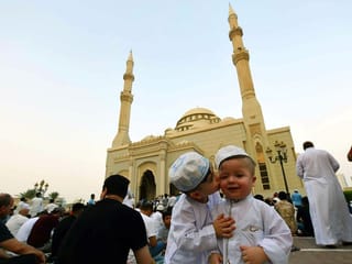 Maan Al Shaar kissing his brother Omer Al Al Shaar after Eid Al Adha prayers at Al Noor Masjid in Sharjah on Eid