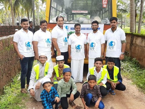 Mohammad Ali, third from left, and other local residents including children volunteering to distribute relief materials sent by PCT Humanity in flood-hit Kerala on Monday.