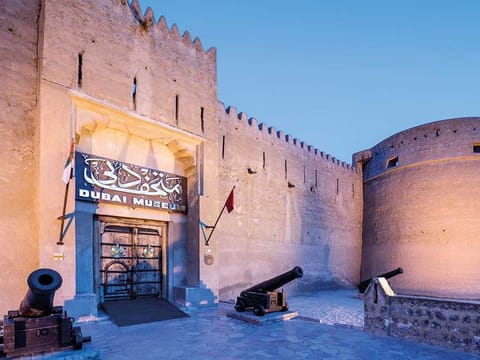 Dubai Museum: Dubai's museum is located in Al-Fahidi Fort. As history goes, the Al-Fahidi Fort was built in 1787 to defend the Dubai Creek. Take this: The fort's walls are built out of traditional coral-blocks and held together with lime. The upper floor is supported by wooden poles, and the ceiling is constructed from palm fronds, mud, and plaster. According to history, the fort served as a residence for the ruling family, a seat of government, garrison, and prison. It was restored in 1971 (and again extensively in 1995), it is now the city's premier museum.  The courtyard is home to several traditional boats and a palm-leaf house with an Emirati wind-tower. The right-hand hall features weaponry, and the left-hand hall showcases Emirati musical instruments. Below the ground floor are display halls with exhibits and dioramas covering various aspects of traditional Emirati life (including pearl fishing and Bedouin desert life), as well as artifacts from the 3,000- to 4,000-year-old graves at Al Qusais archaeological site. Ticket cost: Dh3 for adults and Dh1 for children below six years of age. 