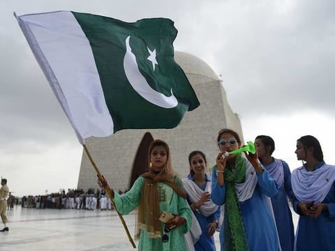 Pakistani girls hold national flag during Independence Day celebrations in Karachi.