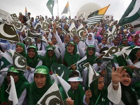 Pakistani students wave Pakistani and Kashmiri flags at the mausoleum of Muhammad Ali Jinnah, founder of Pakistan, to celebrate the Independence Day in Karachi, Pakistan, on Wednesday, August 14, 2019. Pakistanis commemorated their independence from British colonial rule in 1947. 