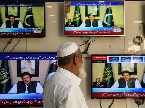  A man watches television as Pakistan's Prime Minister Imran Khan speaks to the nation on Kashmir issue, at an electronic market in Karachi on August 26, 2019