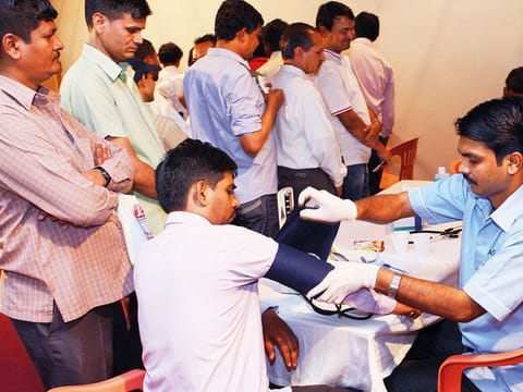 Workers getting themselves examined at a free health camp at Indian Consulate in Dubai 