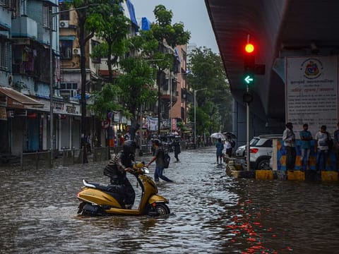 A vehicle wades across a waterlogged street following monsoon rainfall, in Mumbai; Tuesday, Sept 3, 2019