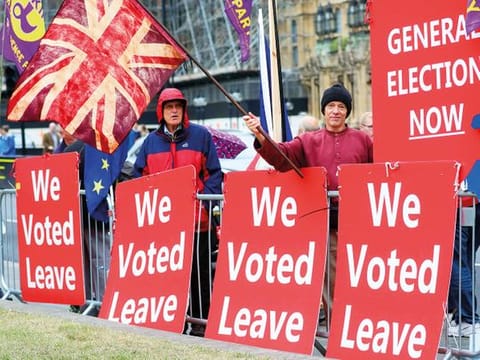 File picture of pro-Brexit protesters with “We Voted Leave” placards outside the Houses of Parliament in London.