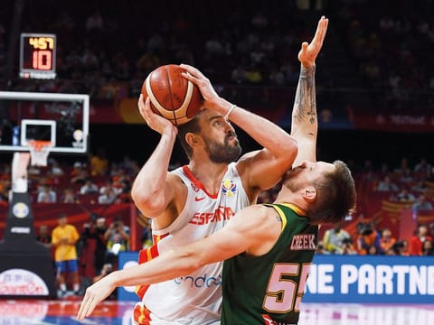 Spain's Marc Gasol (left) fights for the ball with Australia's Patty Mills during the Basketball World Cup semi-final in Beijing on Friday.