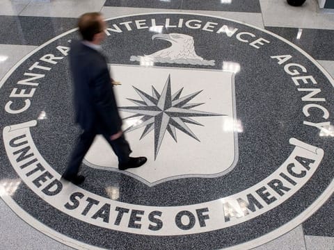 n this file photo taken on August 13, 2008 a man walks over the seal of the Central Intelligence Agency (CIA) in the lobby of CIA Headquarters in Langley, Virginia, on August 14, 2008.  