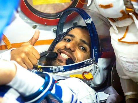  Hazza Al Mansouri flashes a thumbs up as he runs through procedures aboard the Soyuz MS-15 spacecraft during an initial Soyuz vehicle fit check.