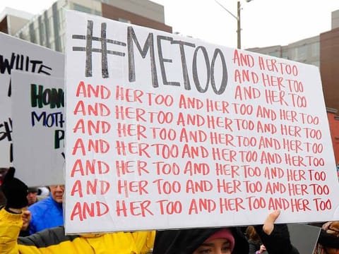 A marcher carries a sign with the popular Twitter hashtag #MeToo used by people speaking out against sexual harassment as she takes part in a Women's March in Seattle, on Jan 20, 2018. 