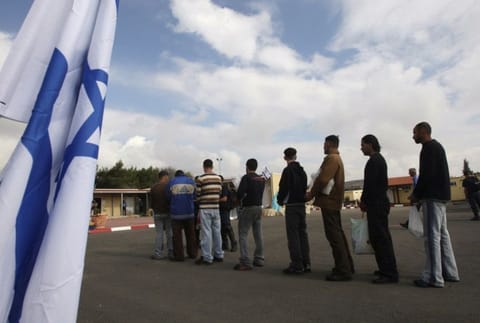 Palestinian prisoners wait in line before their release from Ofer prison, outside the West Bank city of Ramallah, on  December 15, 2008