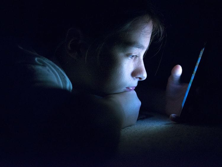 Teenager sending email from smart phone in her bed, Typing text message on smartphone. young cell phone addict teen  awake at night in bed using smartphone for chatting