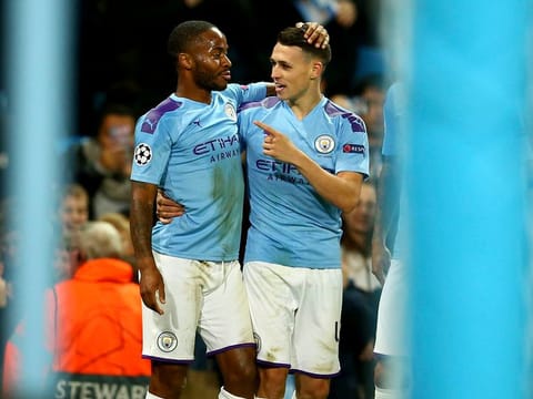 Manchester City's Phil Foden, right, celebrates with Raheem Sterling.