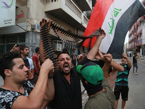 Protesters hold bullets belonging to Iraqi police during a protest in Baghdad, Iraq, Tuesday, Oct. 1, 2019. Iraqi security forces clashed with anti-government protesters in the capital and other provinces Tuesday, killing and injuring civilians, according to officials. (AP Photo/Hadi Mizban)