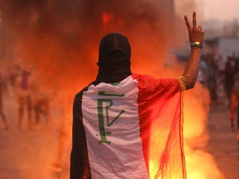 An Iraqi protester gestures the v-sign during a demonstration against failing public services (File image)
