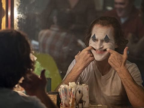 This image released by Warner Bros. Pictures shows Joaquin Phoenix in a scene from "Joker," in theaters on Oct. 4.  (Niko Tavernise/Warner Bros. Pictures via AP)