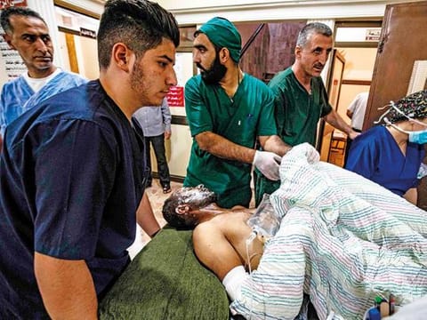 A wounded man receives treatment at a hospital in the northeastern Syrian Kurdish city of Qamishli. 