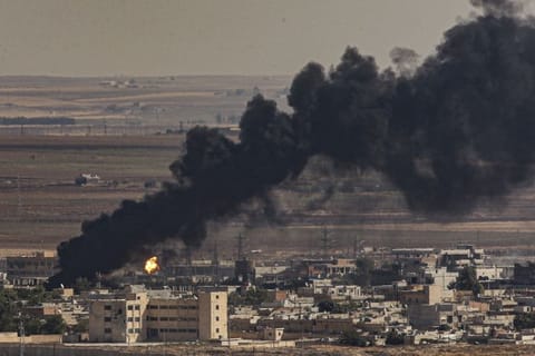 In this photo taken from the Turkish side of the border between Turkey and Syria, in Ceylanpinar, Sanliurfa province, southeastern Turkey, smoke billows from fires on targets in Ras al-Ayn, Syria, caused by bombardment by Turkish forces, Sunday, Oct. 13, 2019