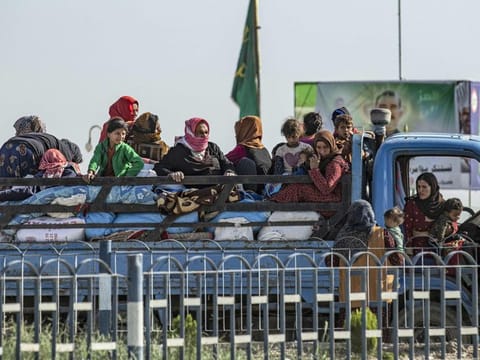 Syrian families fleeing the battle zone between Turkey-led forces and Kurdish fighters from the Syrian Democratic Forces arrive in Tal Tamr on the outskirts of Hasakeh on October 15, 2019. 