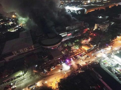Smoke billows from a mall as it catches fire shortly after a strong earthquake struck General Santos city, South Cotabato province, southern Philippines on Wednesday Oct. 16, 2019.