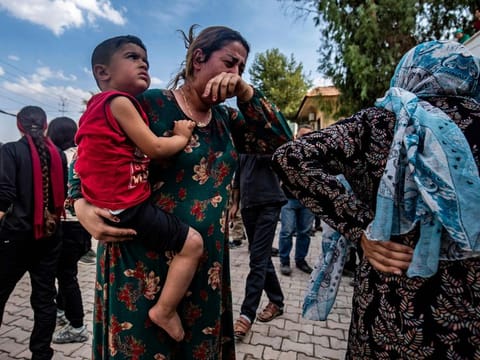 A woman reacts as the body of a man killed during Turkish shelling in the area surrounding the Syrian Kurdish town of Ras al-Ain arrives at a hospital in the nearby town of Tal Tamr following the announced ceasefire on October 18, 2019. 