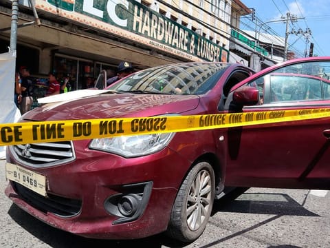 Police check on an Australian named Anthony George inside a car in Olongapo, northern Philippines. 