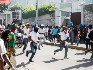 Armed protesters and police officers in plainclothes take to the streets as police officers and their supporters protest in Port-au-Prince. File photo taken on October 27, 2019. 