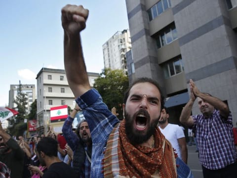 An anti-government protester shots slogans after he was attacked by Hezbollah supporters, in Beirut, Lebanon, Tuesday, Oct. 29, 2019. 