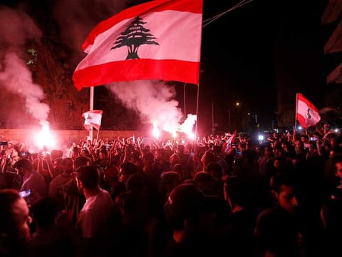 Demonstrators hold flares and Lebanese flags as they protest in Beirut (File) 