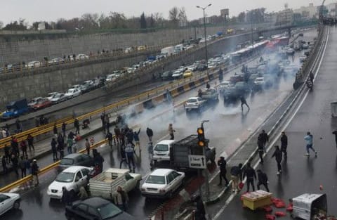 People protest against increased petrol price, on a highway in Tehran, November 16.