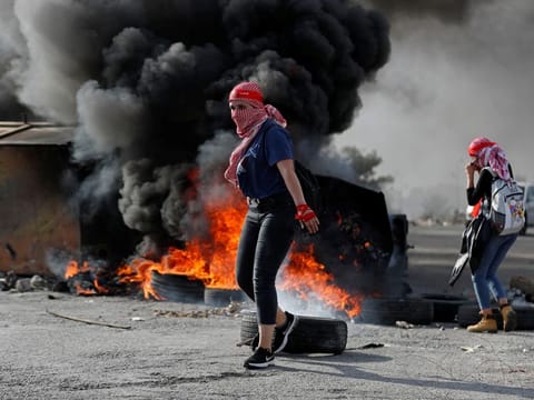 Palestinians protest near the Jewish colony of Beit El in the Israeli-occupied West Bank on November 16, 2019. 