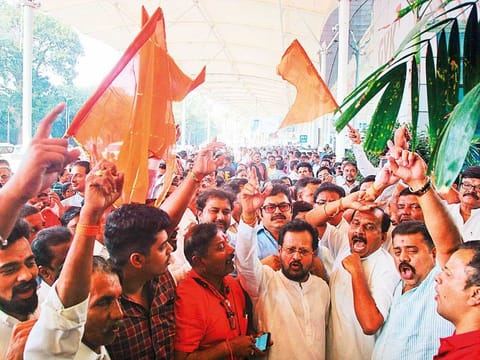 Shiv Sena supporters shout slogans as they celebrate after the resignation of BJP leader Devendra Fadnavis as Maharashtra Chief Minister, in Mumbai on Tuesday. 