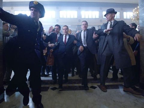 Teamster lawyer Bill Bufalino (Ray Romano) and Frank Sheeran (Robert De Niro) escort Jimmy Hoffa (Al Pacino) to court. 