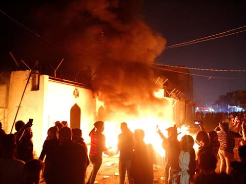 Demonstrators set fire in front of the Iranian consulate, as they gather during ongoing anti-government protests in Najaf, Iraq November 27, 2019.