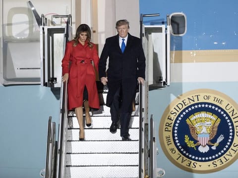 U.S. President Donald Trump, right, and U.S. First Lady Melania Trump disembark from Air Force One after arriving at London Stansted Airport in Stansted, U.K., on Monday, Dec. 2, 2019. 
