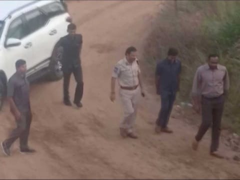 Still frame taken from December 6, 2019 video shows Police Commissioner V.C. Sajjanar and other police officials arriving at a spot where police shot dead four men suspected of raping a veterinary doctor, in Hyderabad, Telangana, India. 