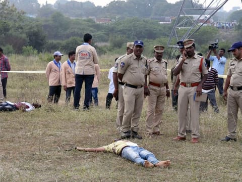 Bodies of the accused in the rape and murder of the veterinarian seen at the spot where they were killed in an "encounter" with the police. 