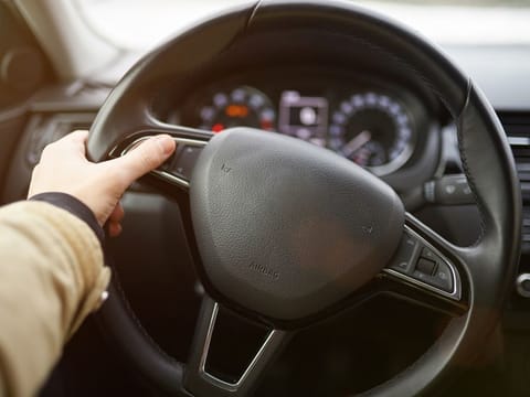 Using buttons on car wheel close up. Pushing button on car wheel