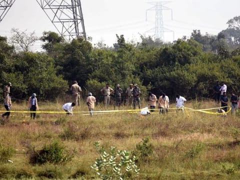Police officers stand guard at the spot where accused in the rape and murder of the woman veterinarian were killed in an encounter, in Hyderabad 