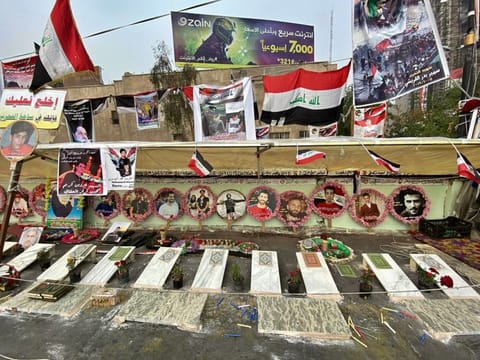 Symbolic graves and posters of anti-government protesters who have been killed in demonstrations are displayed in Tahrir Square, during ongoing protests in Baghdad, Iraq, Sunday, Dec. 15, 2019. 