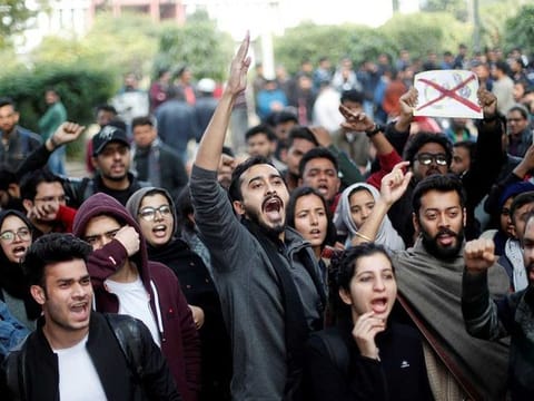 Protesters shout slogans during a protest against the Citizenship Amendment Bill, that seeks to give citizenship to religious minorities persecuted in neighbouring Muslim countries, inside the Jamia Millia Islamia University in New Delhi