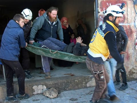 Civil Defence workers evacuate an injured man from the site of airstrikes in the village of Deir Sharqi, in Idlib province, Syria, Tuesday, Dec. 17, 2019. 