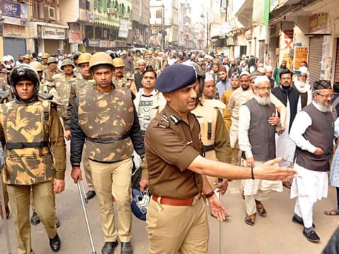 Police personnel patrol march during a protest against the Citizenship Amendment Act, in Varanasi on Friday. 
