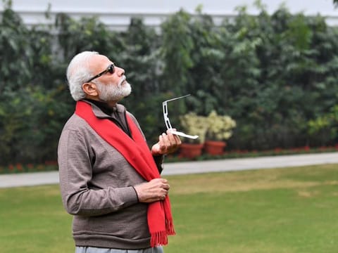 Narendra Modi shared a picture of himself trying to catch a glimpse of the solar eclipse