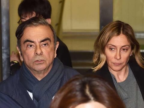Former Nissan Chairman Carlos Ghosn (L) and his wife Carole (R) leave the office of his lawyer in Tokyo.