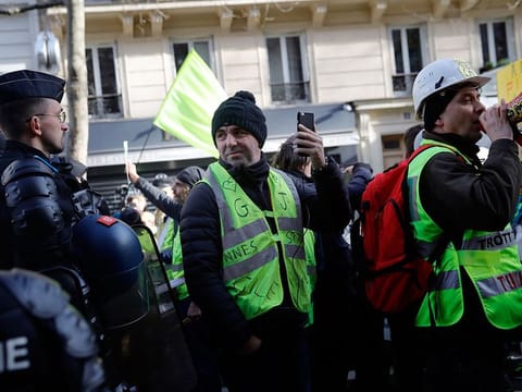 Demonstrators attends a protest against pension reforms in Paris, Saturday, Jan. 3, 2020. A few thousands of protesters marched through Paris to denounce French President Emmanuel Macron's plans to overhaul the pension system, on the 31 day of crippling transport strikes. 